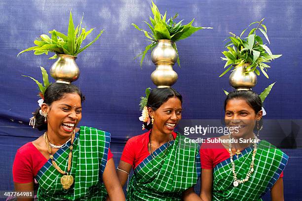 Three Santhali women share a joke before getting ready for a dance during a festive celebration. The Santhal are the largest tribal community in...