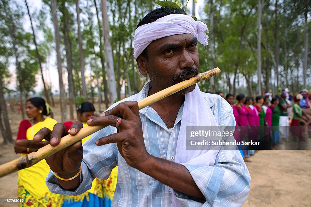 A Santhal man plays flute. The Santhal are the largest...