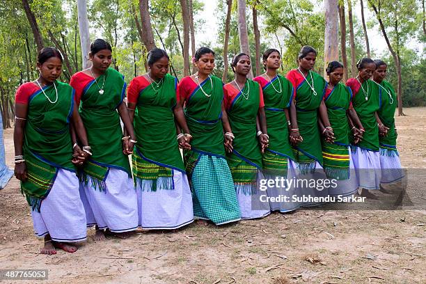 Santhali women dancing in a group. The Santhal are the largest tribal community in India. They have a distinct culture of their own, mainly reflected...