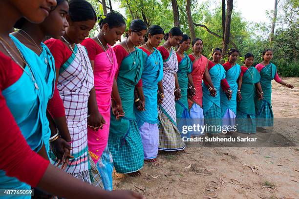 Santhali women dancing in a group. The Santhal are the largest tribal community in India. They have a distinct culture of their own, mainly reflected...