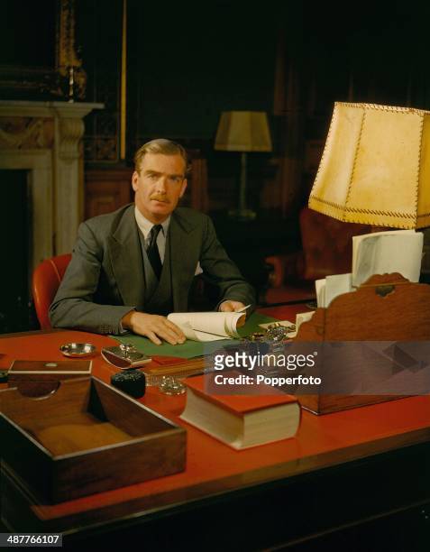 British Foreign Secretary Anthony Eden sitting at his desk in his country home near Chichester during World War Two, England, March 1945. Eden later...
