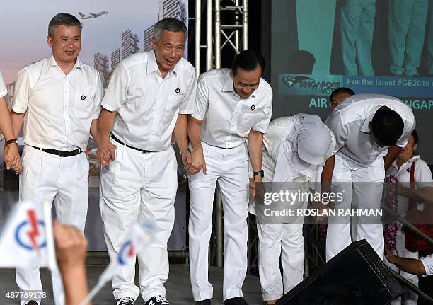 Singapore's Prime Minister Lee Hsien Loong , of the People's Action Party bow to supporters with running mates after winning the general election in...