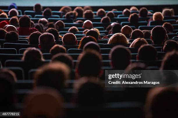 people watching a movie - back of head stockfoto's en -beelden