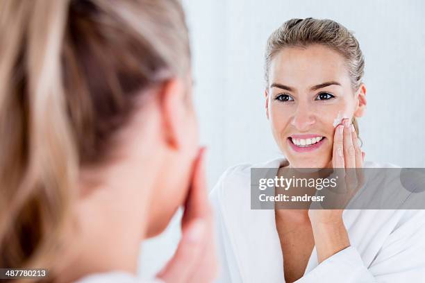 woman hydrating her skin - facial moisturizer stock pictures, royalty-free photos & images