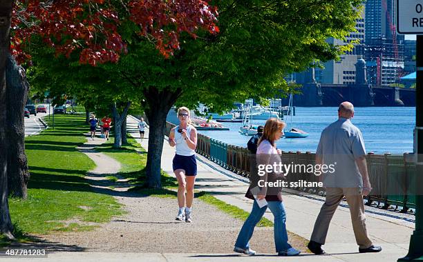 woman jogging in boston - charles river stock pictures, royalty-free photos & images