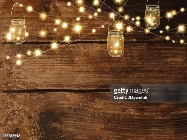 horizontal wooden background with string lights and jars - jdawnink stock illustrations