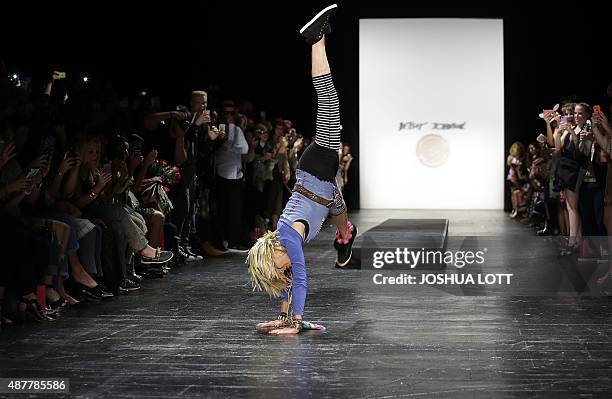 Betsey Johnson does a cartwheel on the runway after showing her Spring/Summer 2016 collection during New York Fashion Week on September 11, 2015. AFP...