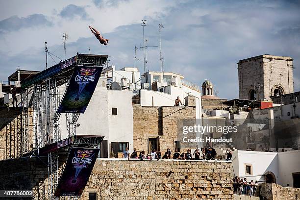 In this handout image provided by Red Bull, Artem Silchenko of Russia dives from the 27.5 metre platform during the first training session of the...