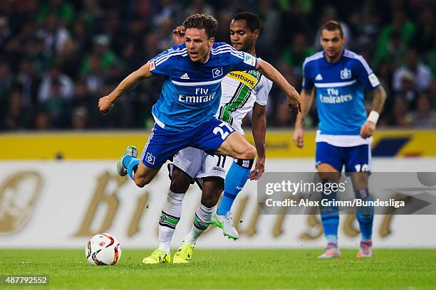 Nicolai Mueller of Hamburg is challenged by Raffael of Moenchengladbach during the Bundesliga match between Borussia Moenchengladbach and Hamburger...