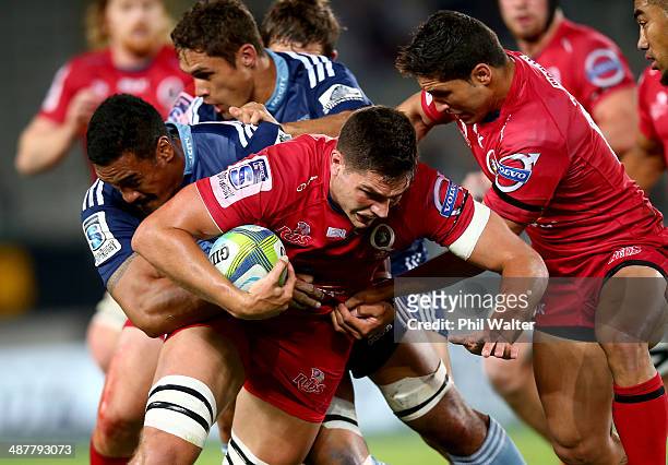 Rob Simmons of the Reds is tackled during the round 12 Super Rugby match between the Blues and the Reds at Eden Park on May 2, 2014 in Auckland, New...