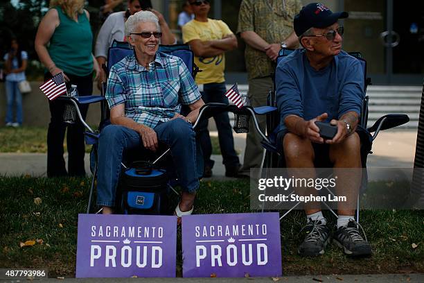 Seated couple watch the parade honoring Alek Skarlatos, Anthony Sadler, and Spencer Stone for their August 21 actions in overpowering a gunman on a...