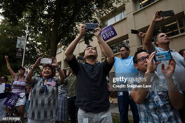 People take photographs of the parade honoring Alek Skarlatos, Anthony Sadler, and Spencer Stone for their August 21 actions in overpowering a gunman...