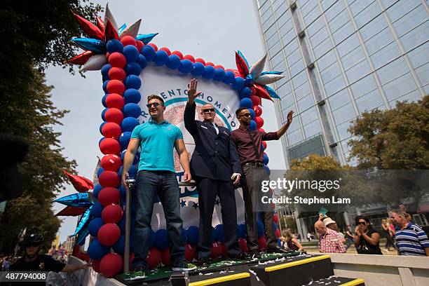 Alek Skarlatos, Spencer Stone, and Anthony Sadler wave to the crowd along Capitol Mall during a parade to honor their August 21 actions in...