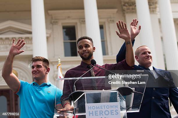 Alek Skarlatos, Anthony Sadler, and Spencer Stone wave to the crowd during a parade honoring their August 21 actions in overpowering a gunman on a...