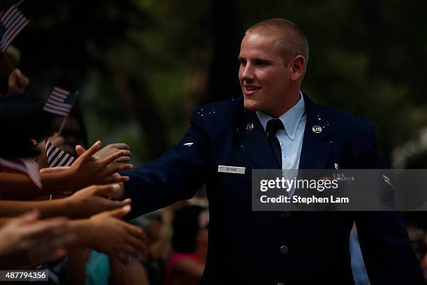 Air Force Airman First Class Spencer Stone shakes hands with the crowd during a parade honoring his August 21 actions in overpowering a gunman on a...