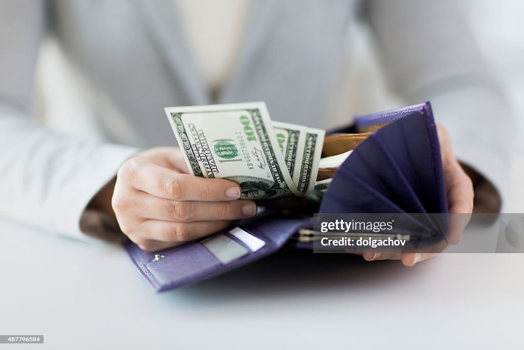 Close up of woman hands with wallet and money