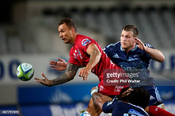 Quade Cooper of the Reds offloads the ball during the round 12 Super Rugby match between the Blues and the Reds at Eden Park on May 2, 2014 in...