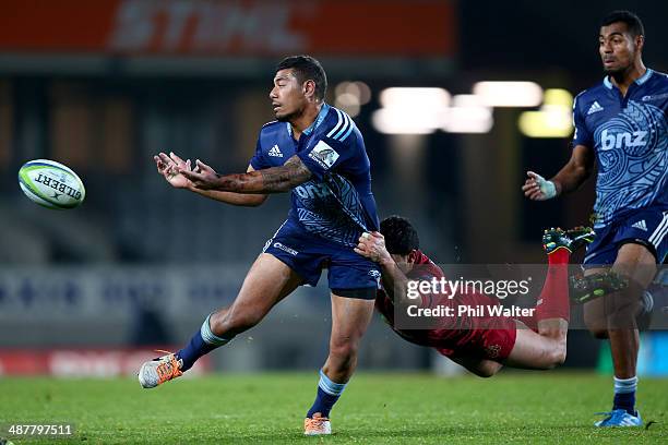 Charles Piutau of the Blues is tackled by Anthony Fainga'a of the Reds during the round 12 Super Rugby match between the Blues and the Reds at Eden...