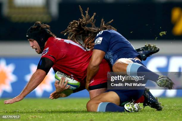 Ben Daley of the Reds is tackled by Ofa Tu'ungafasi of the Blues during the round 12 Super Rugby match between the Blues and the Reds at Eden Park on...