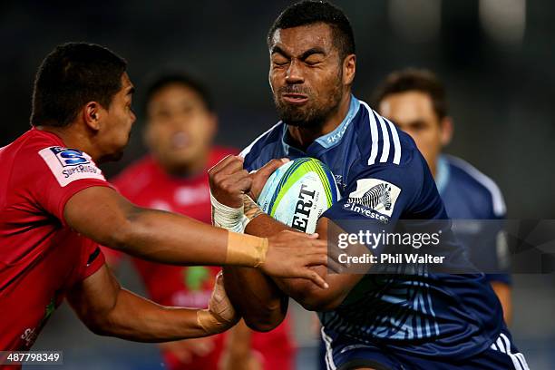 Lolagi Visinia of the Blues is tackled during the round 12 Super Rugby match between the Blues and the Reds at Eden Park on May 2, 2014 in Auckland,...