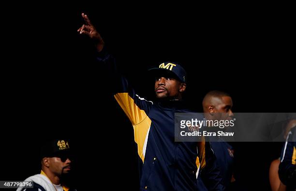 Boxer Floyd Mayweather Jr. Waves to the crowd as he enters the arena for his official weigh-in at MGM Grand Garden Arena on September 11, 2015 in Las...