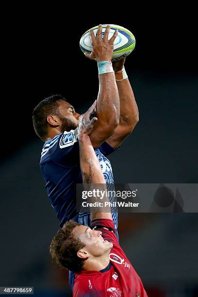 Patrick Tuipulotu of the Blues takes the ball in the lineout above Jake Schatz of the Reds during the round 12 Super Rugby match between the Blues...