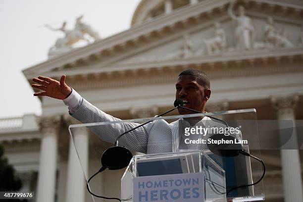 Sacramento Mayor Kevin Johnson speaks on stage during a parade honoring Alek Skarlatos, Anthony Sadler, and Spencer Stone for their August 21 actions...