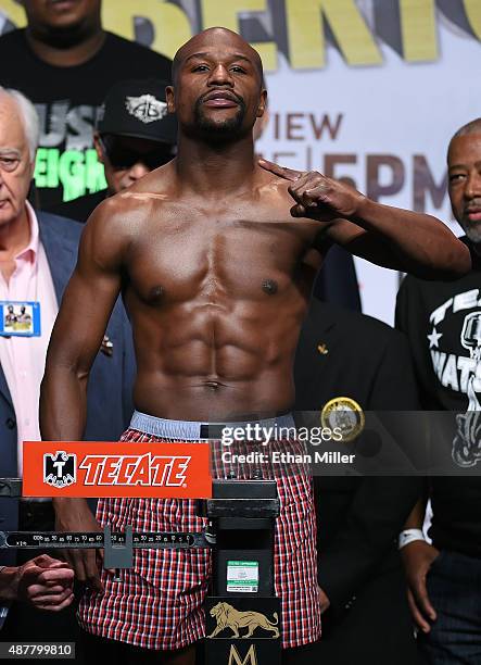 Boxer Floyd Mayweather Jr. Poses on the scale during his official weigh-in at MGM Grand Garden Arena on September 11, 2015 in Las Vegas, Nevada....