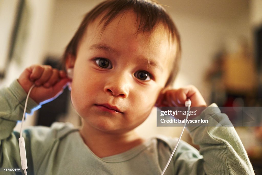 Boy listening music on earbuds