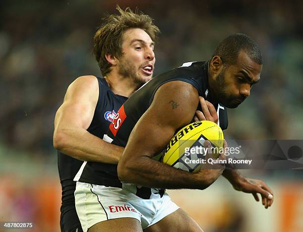 Heritier Lumumba of the Magpies is tackled by Dale Thomas of the Blues during the round seven AFL match between the Carlton Blues and the Collingwood...