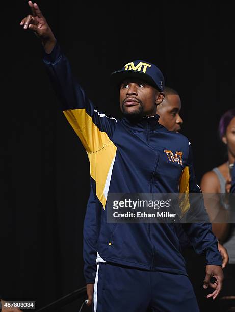 Boxer Floyd Mayweather Jr. Gestures to the crowd as he arrives at his official weigh-in at MGM Grand Garden Arena on September 11, 2015 in Las Vegas,...