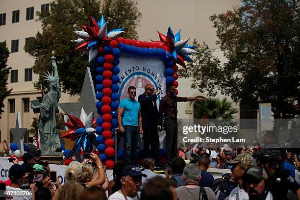 Alek Skarlatos, Spencer Stone, and Anthony Sadler wave to the crowd along Capitol Mall during a parade to honor their August 21 actions in...