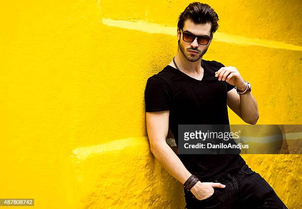 fashionable handsome man isolated on yellow wall - males stock pictures, royalty-free photos & images