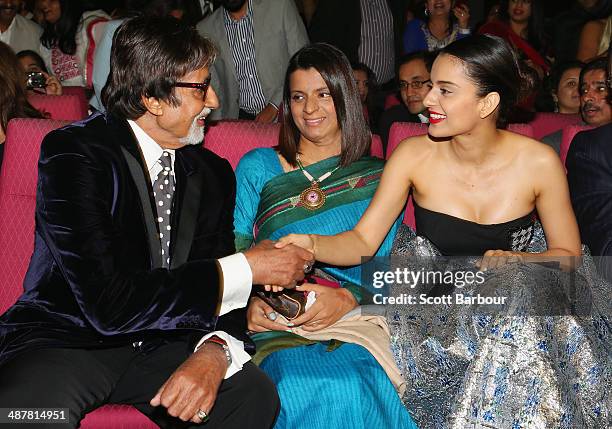 Indian film actor, Amitabh Bachchan greets Indian actress, Kangana Ranaut as her sister Rangoli Ranaut looks on during the Indian Film Festival of...