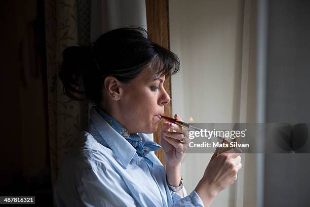 woman lighting a cigarette - premium lighter stock pictures, royalty-free photos & images