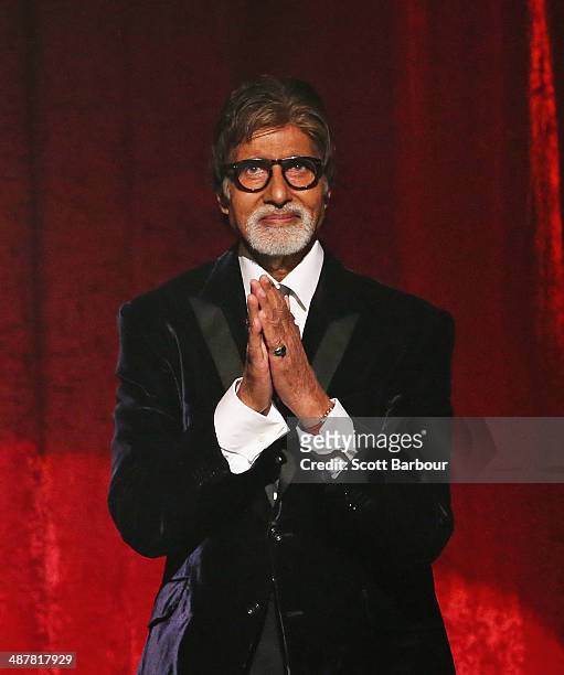 Indian film actor, Amitabh Bachchan gestures on stage as he is presented with the International Screen Icon Award during the Indian Film Festival of...
