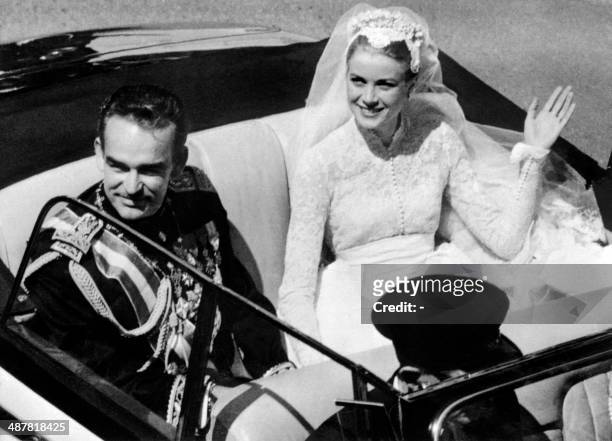 File photo taken on April 19, 1956 shows Prince Rainier III of Monaco and US actress and princess of Monaco Grace Kelly saluting the crowd as they...