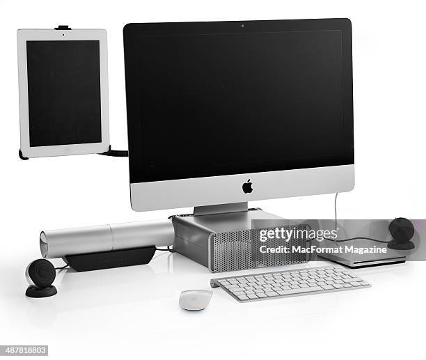 An Apple IMac photographed on a white background with a selection of Apple-compatible accessories and hardware, including an iPad HoverBar, Twelve...
