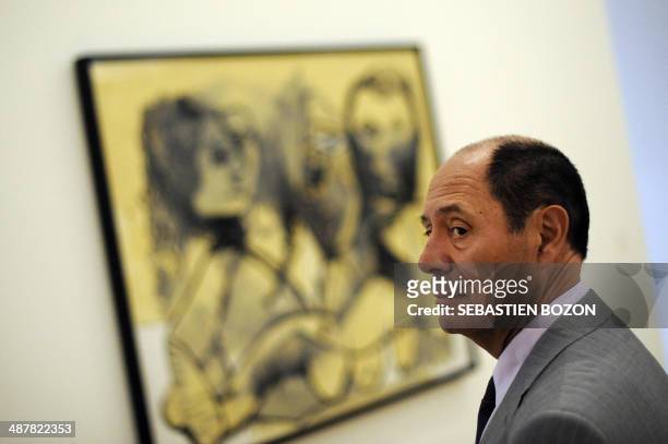 Spanish artist Pablo Picasso's heir Claude Picasso stands by a Picasso canvas entitled "Trois personnages" at the Paul Klee Center in Bern on June...