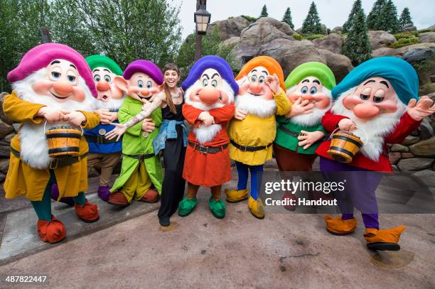 In this handout photo provided by Disney Parks, singer/songwriter Christina Perri joins Disney's Seven Dwarfs at the Magic Kingdom park May 2, 2014...