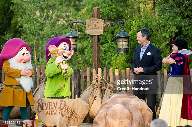 In this handout photo provided by Disney Parks, Tom Staggs, chairman of Walt Disney Parks & Resorts, joins Disney characters Sleepy Dwarf, Dopey and...