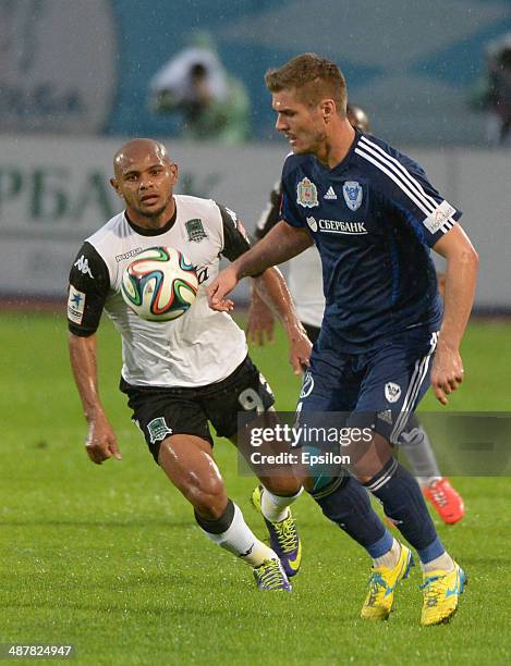 Marcin Kowalczyk of FC Volga Nizhny Novgorod challenged by Ari of FC Krasnodar during the Russian Premier League match between FC Volga Nizhny...