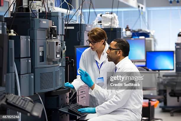 menschen arbeiten mit specialist wissenschaftliche ausstattung für messen chemikalien. - medizinisches gerät stock-fotos und bilder