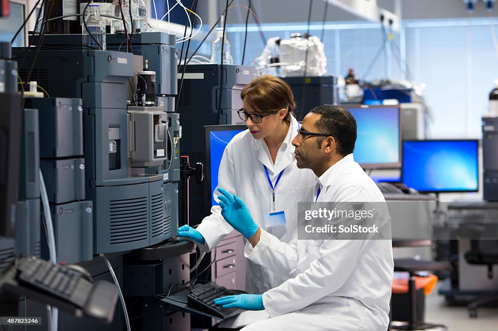 People Working with Specialist Scientific Equipment for Measuring Chemicals.