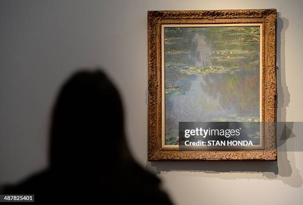 Person views Claude Monet's "Nympheas", painted in 1907, on display May 2, 2014 during a preview of the Impressionist and Modern Art sale at...