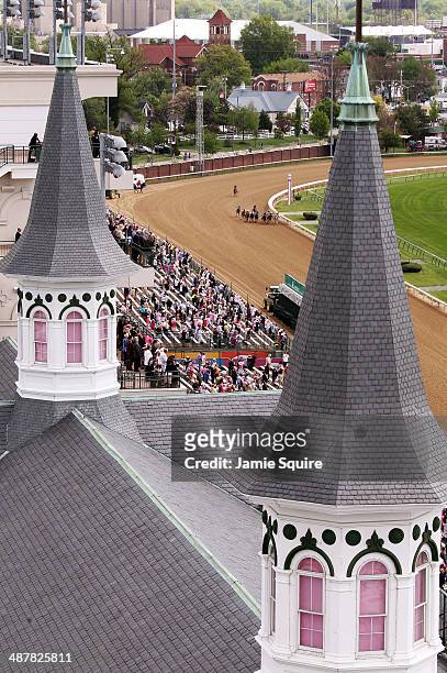 Pack of horses rounds the final bend as seen through the twin spires during the 3rd race ahead of the 140th Kentucky Oaks at Churchill Downs on May...