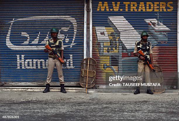 Indian paramilitary troops stand guard during a curfew in the Maisuma locality of Srinagar on May 2, 2014. Parts of Kashmir remained under curfew for...