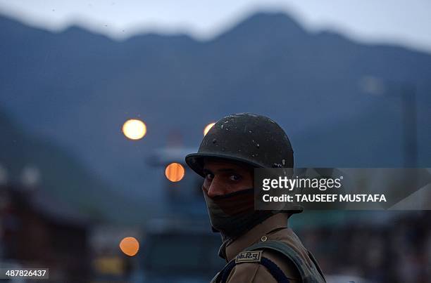 An Indian paramilitary trooper looks on during a curfew in the Maisuma locality of Srinagar on May 2, 2014. Parts of Kashmir remained under curfew...