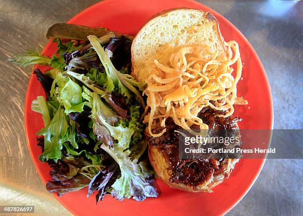 The pulled pork sandwich is served with onion strings, a side salad with house vinaigrette dressing and a pickle. For the Eat and Run review of the...