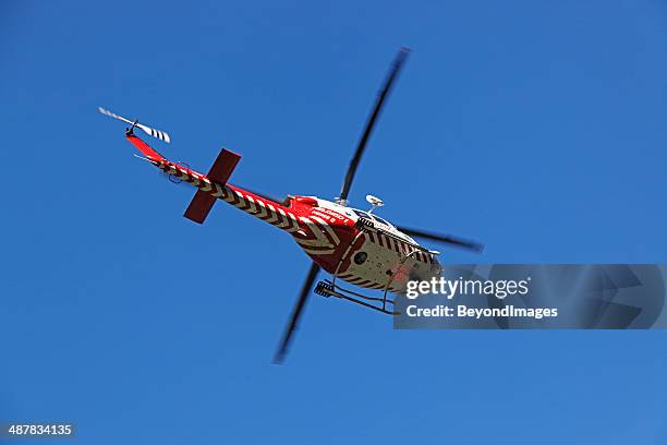 air ambulance helicopter evacuates rural accident victim to hospital - helicopter ambulance stock pictures, royalty-free photos & images